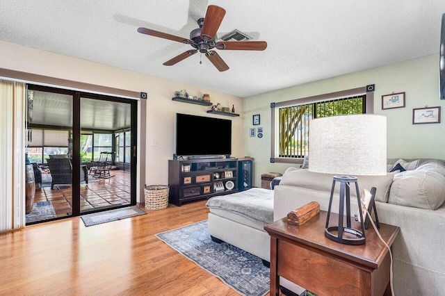 129 Parkwood Dr, Royal Palm Beach, FL 33411 - living room featuring plenty of natural light, wood finished floors, a ceiling fan, and a textured ceiling