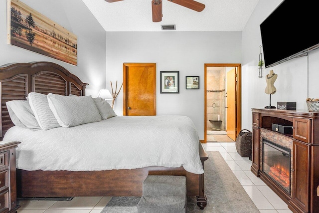 129 Parkwood Dr, Royal Palm Beach, FL 33411 - bedroom featuring light tile patterned floors, a fireplace with flush hearth, a ceiling fan, and connected bathroom