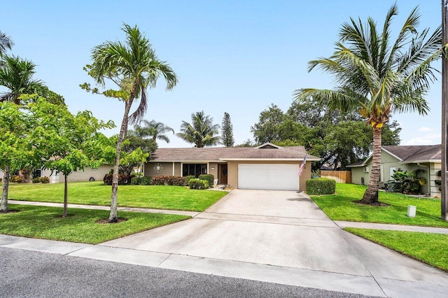 129 Parkwood Dr, Royal Palm Beach, FL 33411 - ranch-style home with a garage, driveway, and stucco siding