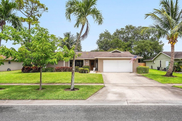 129 Parkwood Dr, Royal Palm Beach, FL 33411 - ranch-style house featuring an attached garage, a front yard, driveway, and stucco siding