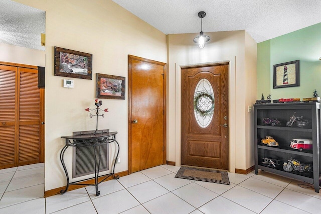 129 Parkwood Dr, Royal Palm Beach, FL 33411 - foyer entrance with a textured ceiling, light tile patterned flooring, and baseboards