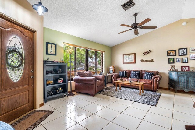 129 Parkwood Dr, Royal Palm Beach, FL 33411 - foyer with lofted ceiling, light tile patterned flooring, a textured ceiling, and ceiling fan