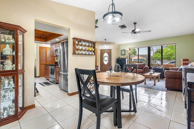 129 Parkwood Dr, Royal Palm Beach, FL 33411 - dining space with ceiling fan, light tile patterned floors, baseboards, and a textured ceiling