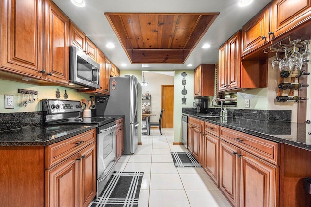 129 Parkwood Dr, Royal Palm Beach, FL 33411 - kitchen featuring appliances with stainless steel finishes, a tray ceiling, a sink, brown cabinetry, and wooden ceiling
