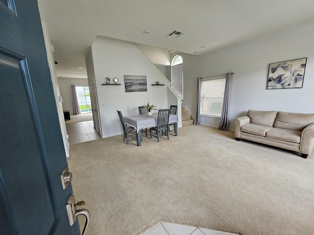 426 Cadiz Loop, Davenport, FL 33837 - carpeted living area featuring stairs and baseboards