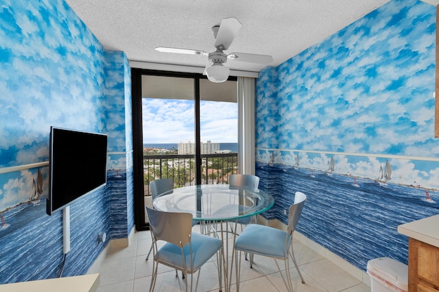 4740 S Ocean Blvd Unit 1403, Highland Beach, FL 33487 - tiled dining room with wallpapered walls, a ceiling fan, a textured ceiling, and baseboards