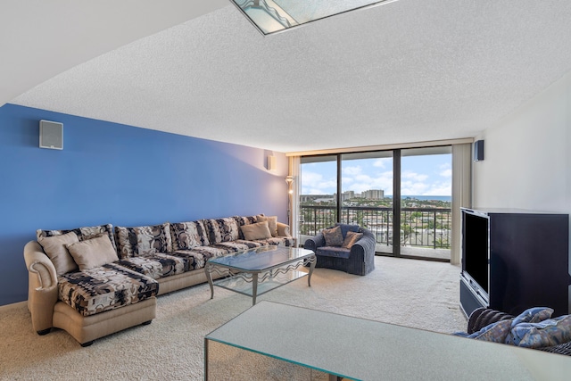 4740 S Ocean Blvd Unit 1403, Highland Beach, FL 33487 - living area featuring carpet floors, floor to ceiling windows, and a textured ceiling