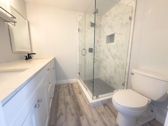 7724 77th Way, West Palm Beach, FL 33407 - bathroom featuring wood finished floors, double vanity, and a marble finish shower
