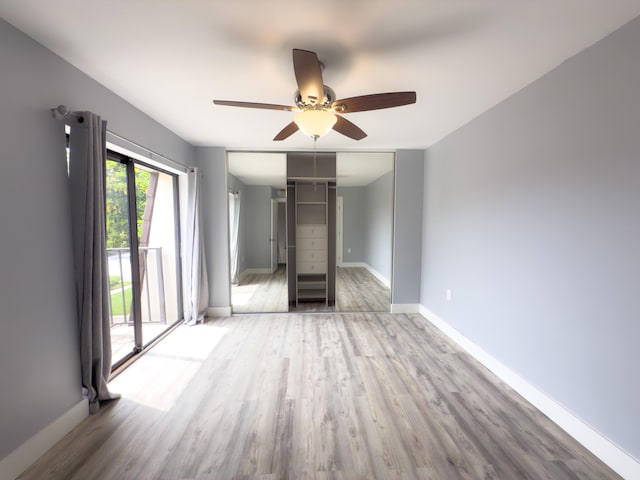 7724 77th Way, West Palm Beach, FL 33407 - unfurnished living room with wood finished floors and a ceiling fan