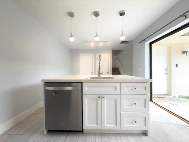 7724 77th Way, West Palm Beach, FL 33407 - kitchen featuring stainless steel dishwasher, white cabinets, hanging light fixtures, and light countertops
