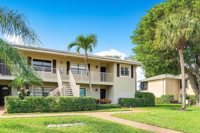 36 Stratford Ln Unit H, Boynton Beach, FL 33436 - view of building exterior featuring stairway