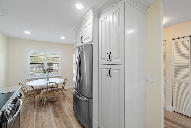36 Stratford Ln Unit H, Boynton Beach, FL 33436 - kitchen featuring stainless steel appliances, wood finished floors, white cabinetry, and recessed lighting