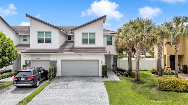 4340 Lago Dr, Deerfield Beach, FL 33064 - multi unit property with an attached garage, decorative driveway, stucco siding, and a tile roof
