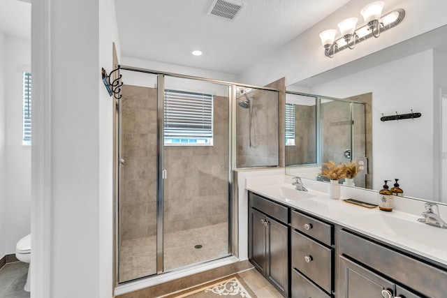 4340 Lago Dr, Deerfield Beach, FL 33064 - full bathroom featuring double vanity, a stall shower, tile patterned floors, toilet, and recessed lighting