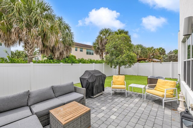 4340 Lago Dr, Deerfield Beach, FL 33064 - fenced backyard featuring grilling area, outdoor lounge area, a patio, and central air condition unit