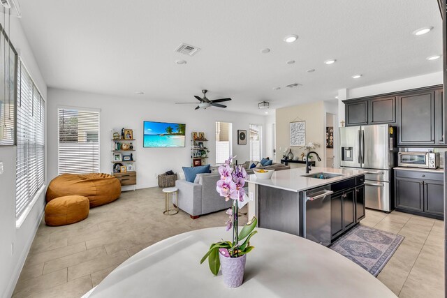 4340 Lago Dr, Deerfield Beach, FL 33064 - kitchen featuring stainless steel appliances, a sink, light tile patterned floors, a breakfast bar, and recessed lighting