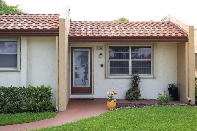 106 Lake Helen Dr, West Palm Beach, FL 33411 - property entrance featuring stucco siding and a tiled roof