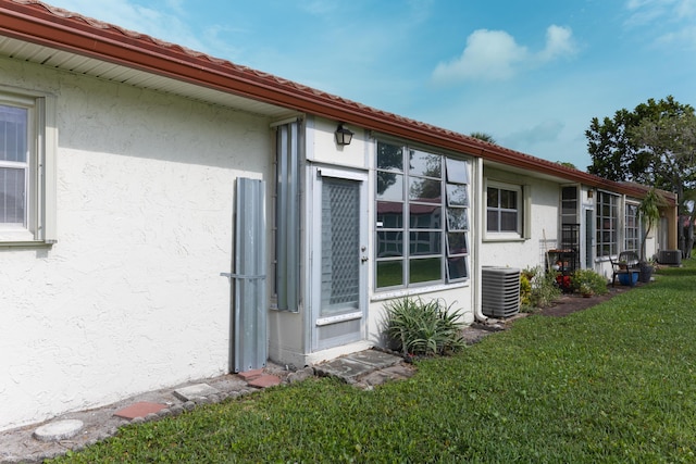 106 Lake Helen Dr, West Palm Beach, FL 33411 - view of side of property featuring stucco siding, a yard, and central air condition unit