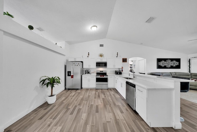 3990 Halcomb St, Port Saint Lucie, FL 34953 - kitchen with stainless steel appliances, arched walkways, a peninsula, a sink, and light countertops