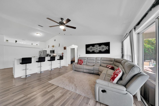 3990 Halcomb St, Port Saint Lucie, FL 34953 - living room with lofted ceiling, arched walkways, a ceiling fan, and light wood-style floors