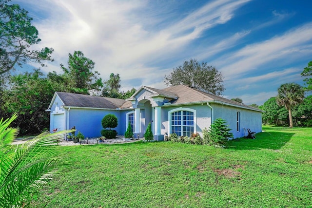 3990 Halcomb St, Port Saint Lucie, FL 34953 - ranch-style home with stucco siding, a garage, and a front lawn
