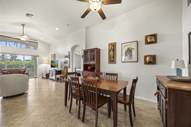 7116 Trentino Way, Boynton Beach, FL 33472 - dining space with a ceiling fan, high vaulted ceiling, light tile patterned floors, arched walkways, and baseboards