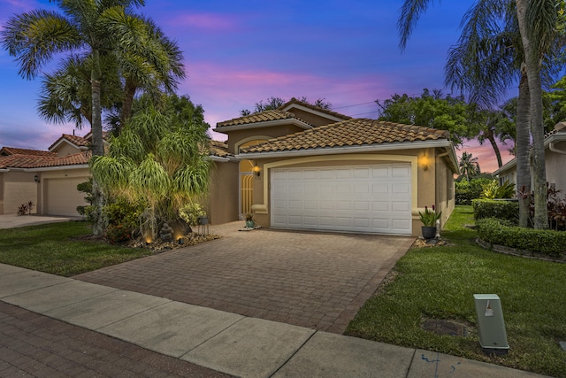 7116 Trentino Way, Boynton Beach, FL 33472 - mediterranean / spanish-style home with stucco siding, a garage, driveway, and a yard