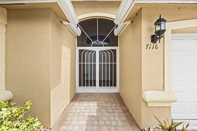 7116 Trentino Way, Boynton Beach, FL 33472 - property entrance featuring stucco siding and a garage
