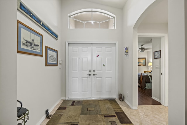 7116 Trentino Way, Boynton Beach, FL 33472 - entrance foyer featuring arched walkways, baseboards, ceiling fan, and tile patterned flooring