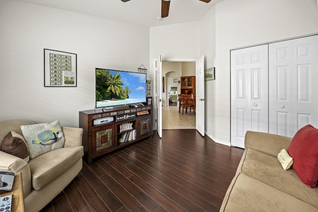 7116 Trentino Way, Boynton Beach, FL 33472 - living area featuring ceiling fan, wood finished floors, arched walkways, baseboards, and a towering ceiling