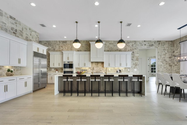 10032 Calabrese Trl, Jupiter, FL 33478 - kitchen featuring appliances with stainless steel finishes, recessed lighting, tasteful backsplash, light countertops, and white cabinetry