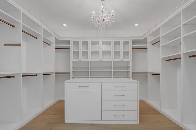 10032 Calabrese Trl, Jupiter, FL 33478 - walk in closet with light wood-style flooring and a chandelier