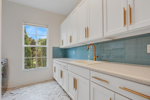 10032 Calabrese Trl, Jupiter, FL 33478 - kitchen with a sink, white cabinets, and decorative backsplash