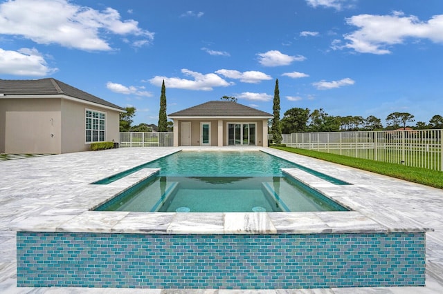 10032 Calabrese Trl, Jupiter, FL 33478 - view of swimming pool with a pool with connected hot tub, an outdoor structure, a patio, and an exterior structure