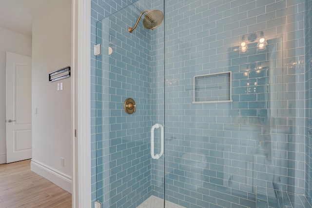 10032 Calabrese Trl, Jupiter, FL 33478 - bathroom featuring a shower stall, wood finished floors, and baseboards