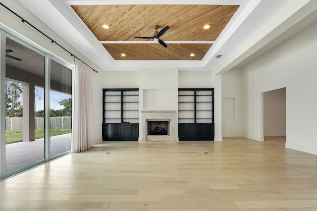 10032 Calabrese Trl, Jupiter, FL 33478 - unfurnished living room with a ceiling fan, wooden ceiling, a raised ceiling, light wood-style flooring, and a fireplace
