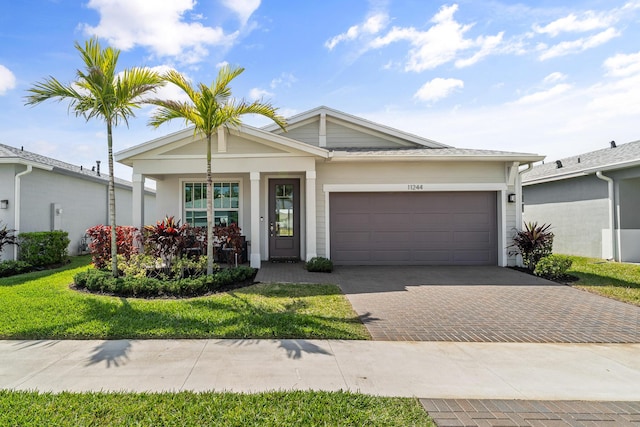 11244 SW Lyra Dr, Port Saint Lucie, FL 34987 - ranch-style house with decorative driveway, an attached garage, and a front lawn