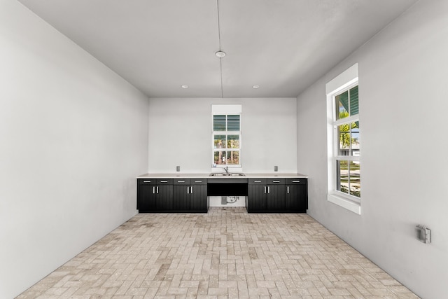 11244 SW Lyra Dr, Port Saint Lucie, FL 34987 - bar featuring a sink, brick patterned floors, and plenty of natural light