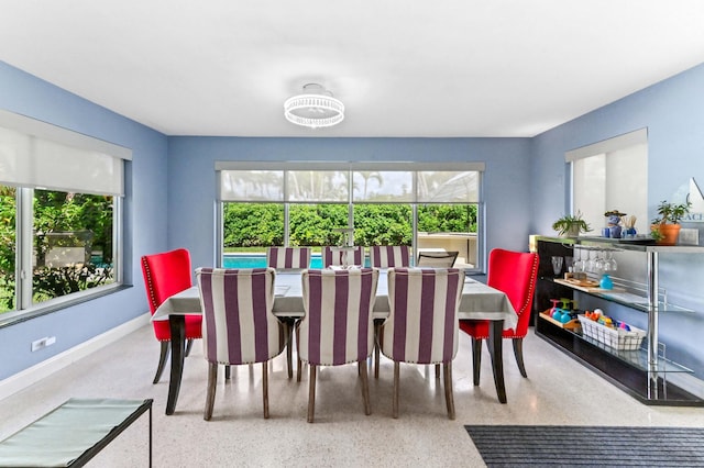 4311 NE 16th Ave, Oakland Park, FL 33334 - dining area featuring speckle patterned floor and baseboards