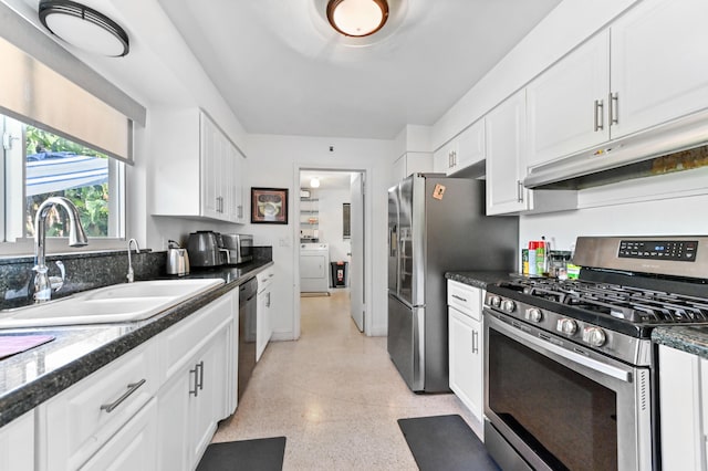 4311 NE 16th Ave, Oakland Park, FL 33334 - kitchen with stainless steel appliances, washer / clothes dryer, and white cabinets