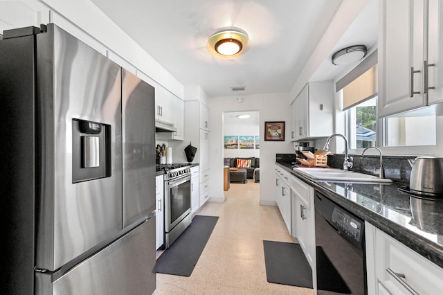 4311 NE 16th Ave, Oakland Park, FL 33334 - kitchen featuring appliances with stainless steel finishes, white cabinets, under cabinet range hood, and dark speckled floor