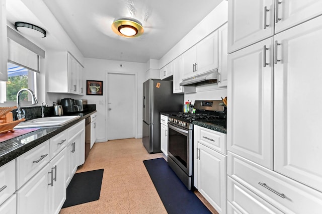 4311 NE 16th Ave, Oakland Park, FL 33334 - kitchen featuring stainless steel appliances, white cabinetry, under cabinet range hood, and dark countertops