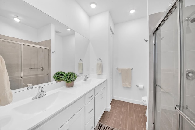 14517 Three Ponds Trl, Delray Beach, FL 33446 - full bathroom with double vanity, a shower stall, toilet, baseboards, and recessed lighting