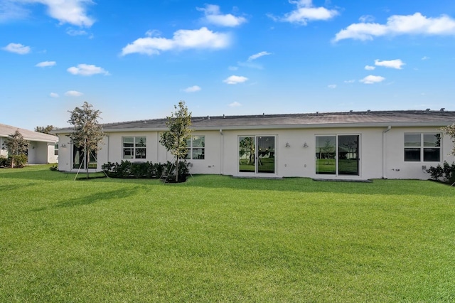 14517 Three Ponds Trl, Delray Beach, FL 33446 - back of property with stucco siding and a yard