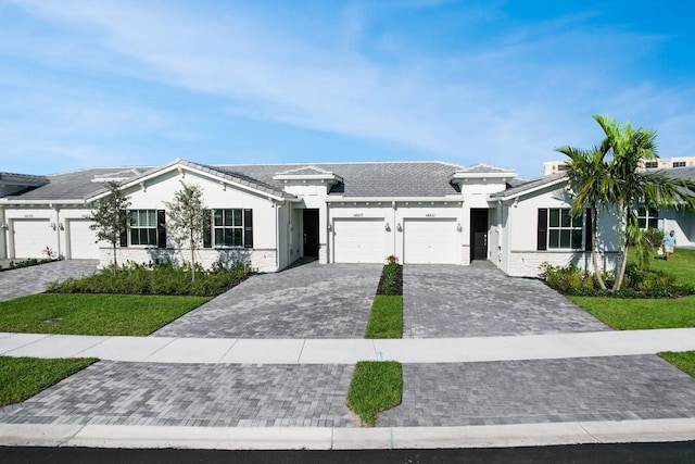 14517 Three Ponds Trl, Delray Beach, FL 33446 - view of front of property featuring a garage, decorative driveway, stucco siding, and a front lawn