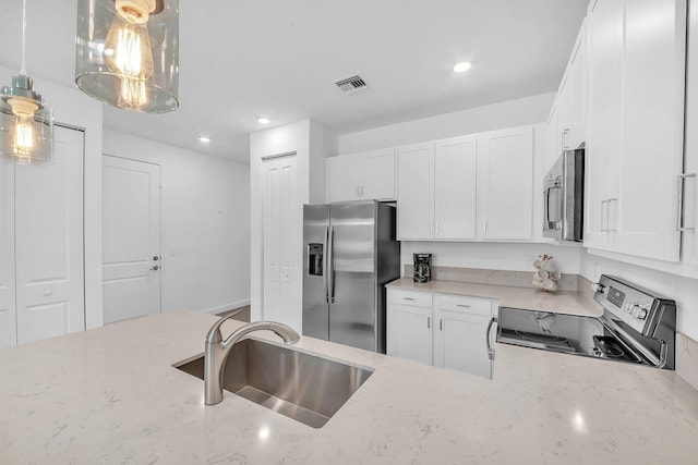 14517 Three Ponds Trl, Delray Beach, FL 33446 - kitchen with appliances with stainless steel finishes, a sink, white cabinets, and recessed lighting