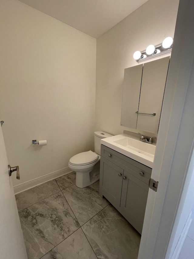 1225 NW 21st St NW Unit 15-1505, Stuart, FL 34994 - bathroom featuring marble look tile flooring, vanity, toilet, and baseboards