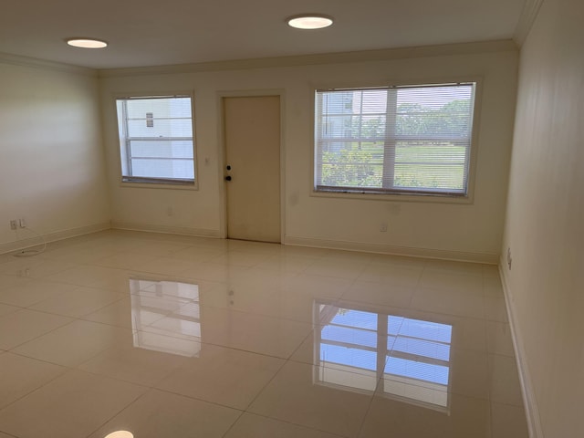 1225 NW 21st St NW Unit 15-1505, Stuart, FL 34994 - empty room with crown molding, light tile patterned floors, and baseboards