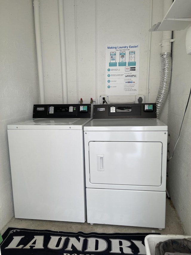 1225 NW 21st St NW Unit 15-1505, Stuart, FL 34994 - shared laundry room with washing machine and clothes dryer and concrete block wall