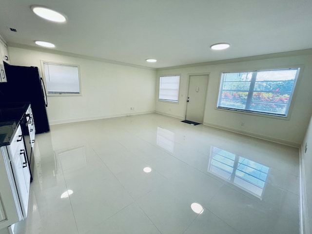 1225 NW 21st St NW Unit 15-1505, Stuart, FL 34994 - unfurnished living room featuring baseboards, crown molding, recessed lighting, and light tile patterned floors
